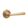 brass lever handle on round rose with escutcheons for interior and main doors